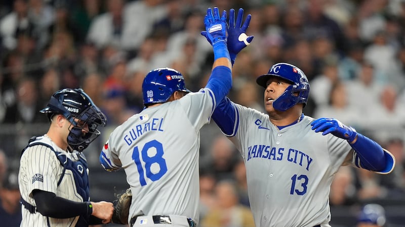 Kansas City Royals' Salvador Perez (13) celebrates with Yuli Gurriel (18) after hitting a solo...