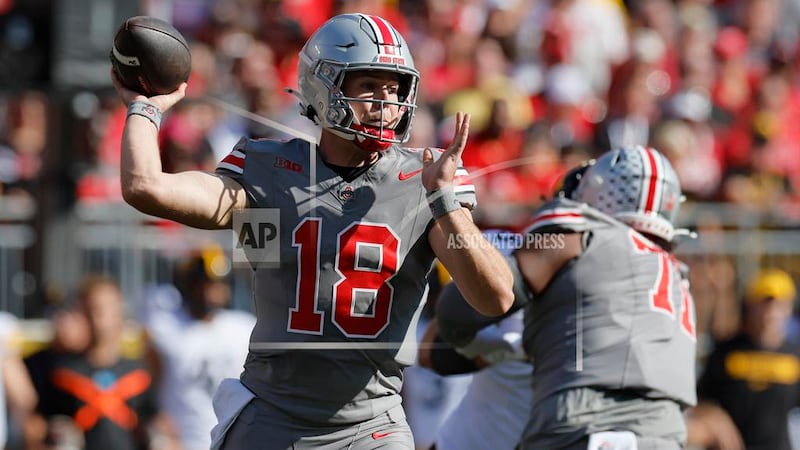 Ohio State quarterback Will Howard throws a pass against Iowa during the first half of an NCAA...