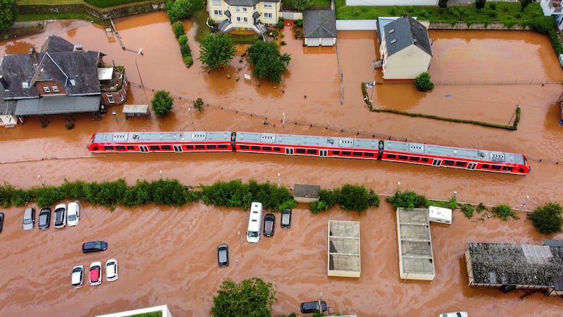 A regional train sits in the flood waters at the local station in Kordel, Germany, Thursday...