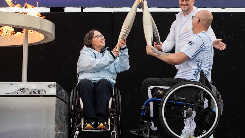 FILE - British Paralympians Helene Raynsford and Gregor Ewan light the Paralympic Flame in...