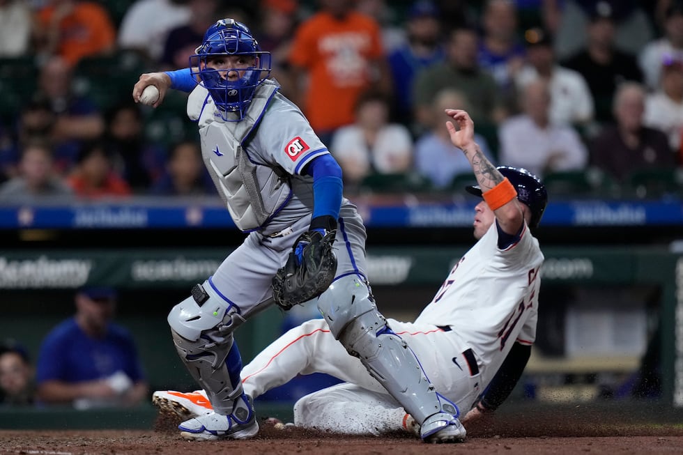 Kansas City Royals catcher Freddy Fermin, left, forces out Houston Astros' Victor Caratini at...